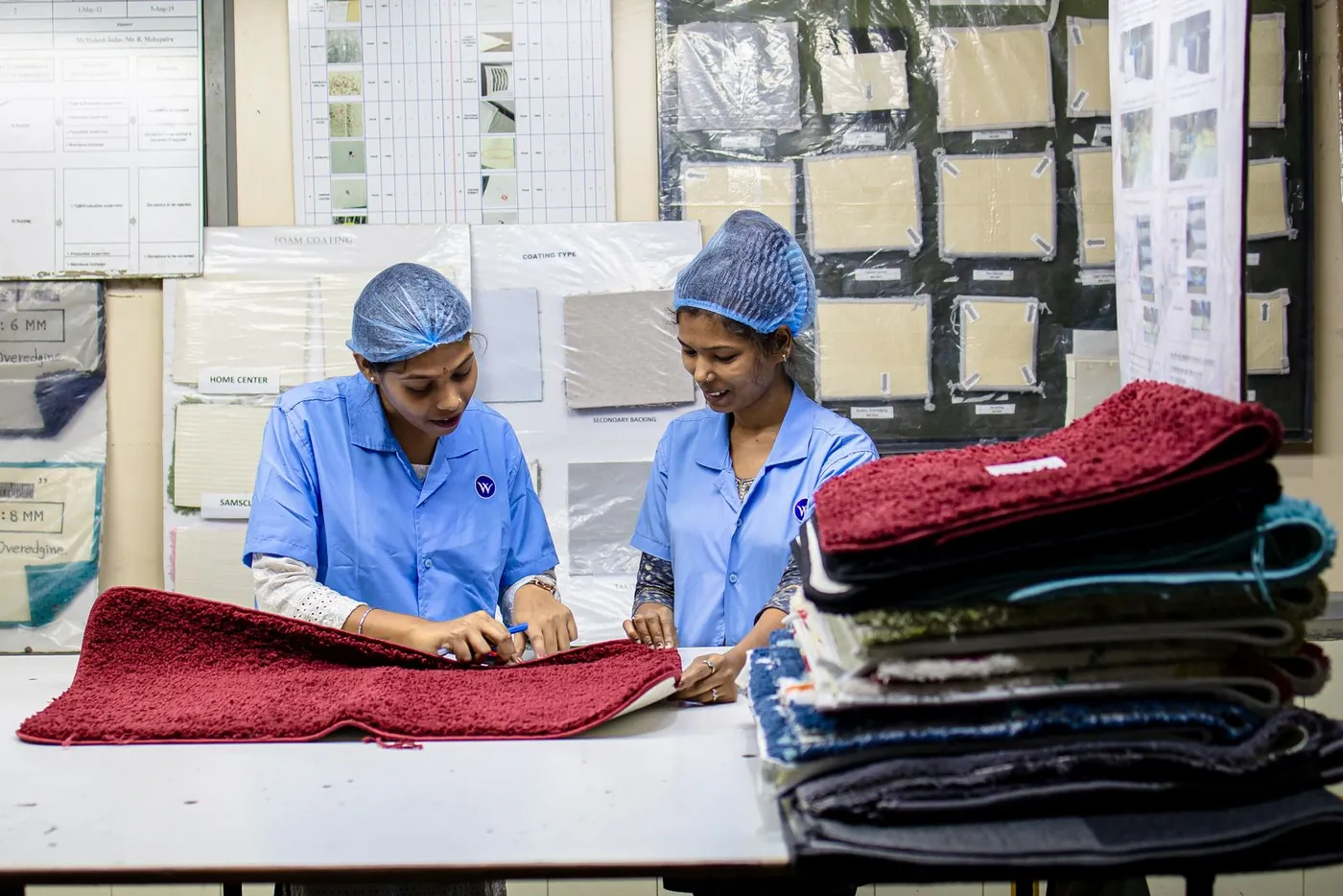 Two workers inspecting a product sample